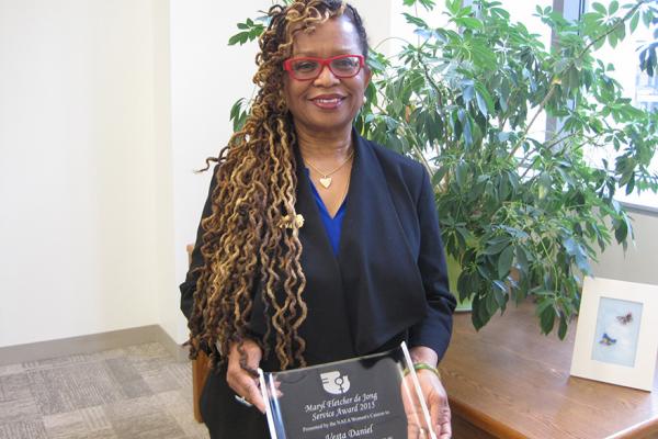 Dr. Daniel holding her 2015 Maryl Fletcher de Jong Service Award plaque