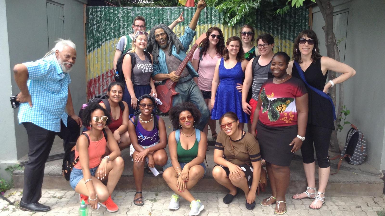 ARTEDUC 5797.02 Exploring Jamaican Arts and Culture study abroad students pose with reggae musician and music educator Michael "Ibo" Cooper (left) at Trench Town Culture Yard, Kingston, Jamaica.