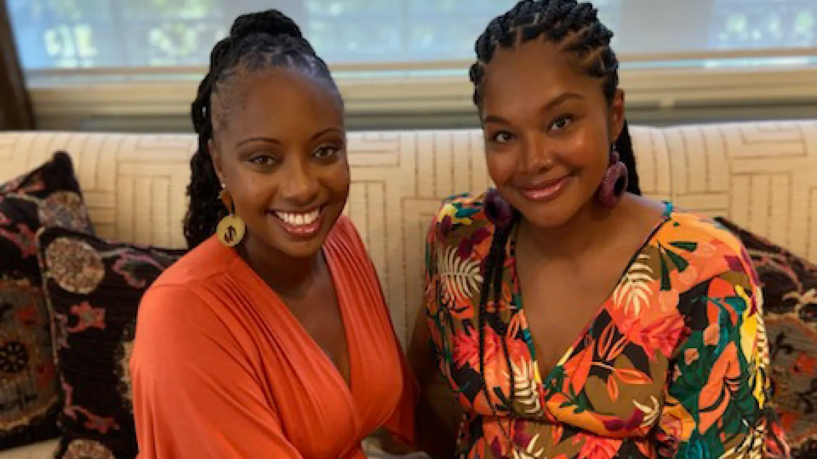 Two women smile at camera