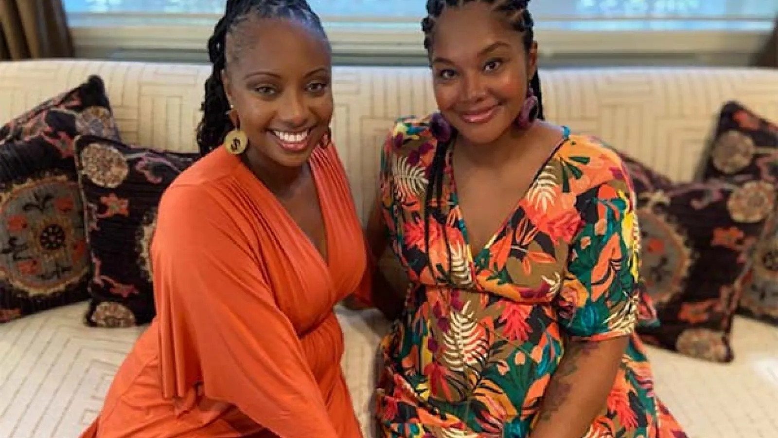 Two women smile in photo at camera