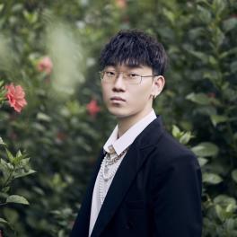 Man in front of trees looking at camera