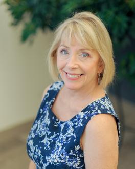 Woman with blonde hair smiling at camera