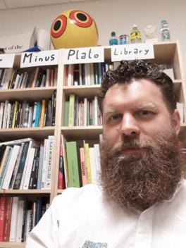 Professor Richard Finlay Fletcher sitting in front of bookshelf