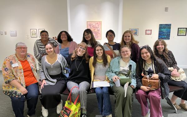 A group of students take a photo in a library