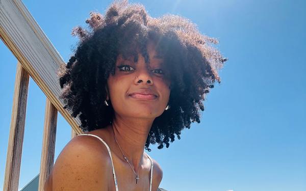 A woman in front of a bright blue sky