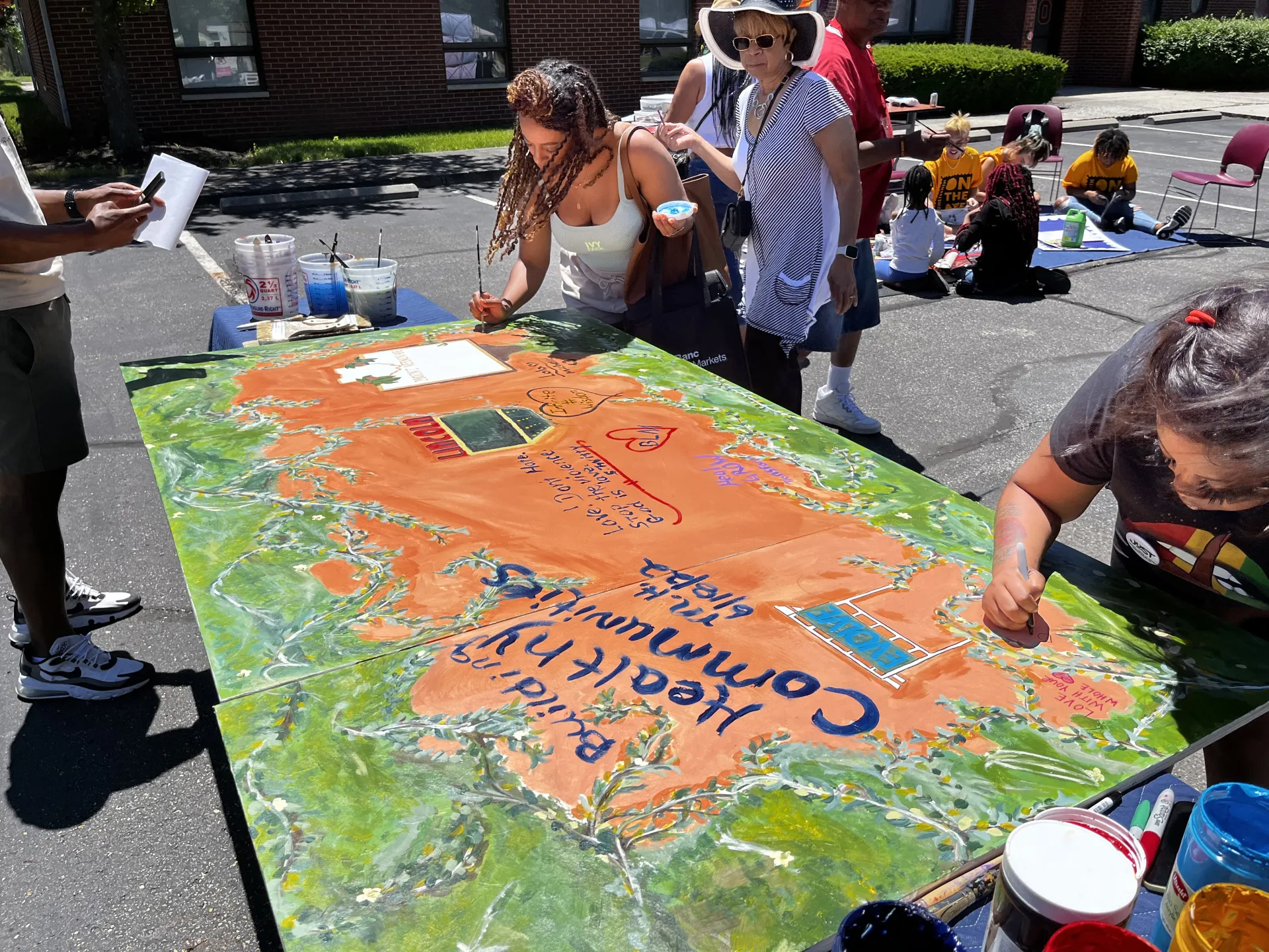 Participants work on creating mural