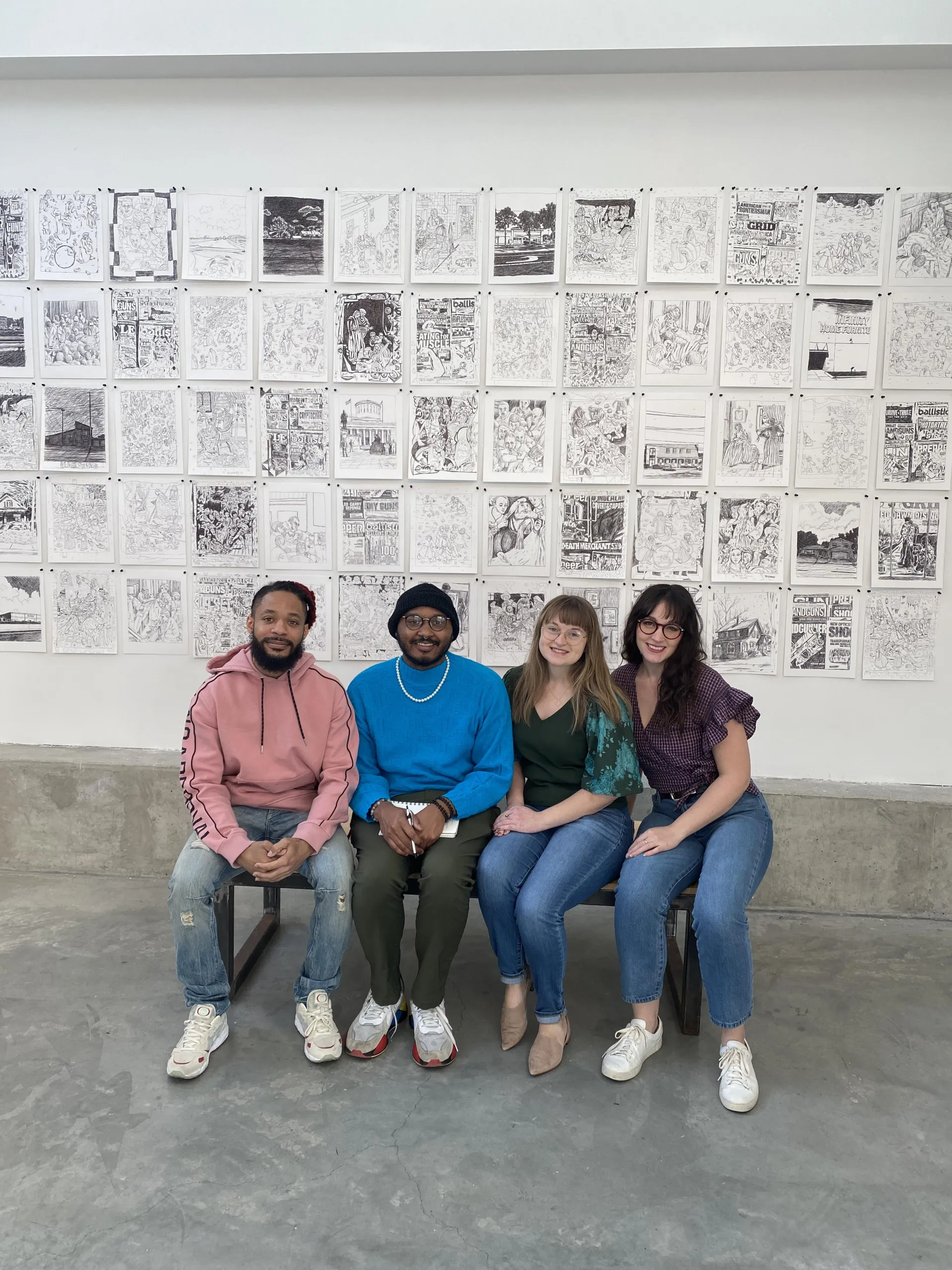 Barnett fellows in front of art on wall