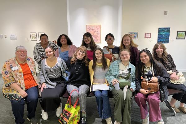 A group of students take a photo in a library