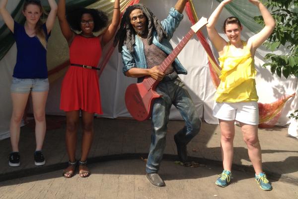 Students pose with a statue of Bob Marley in Jamaica
