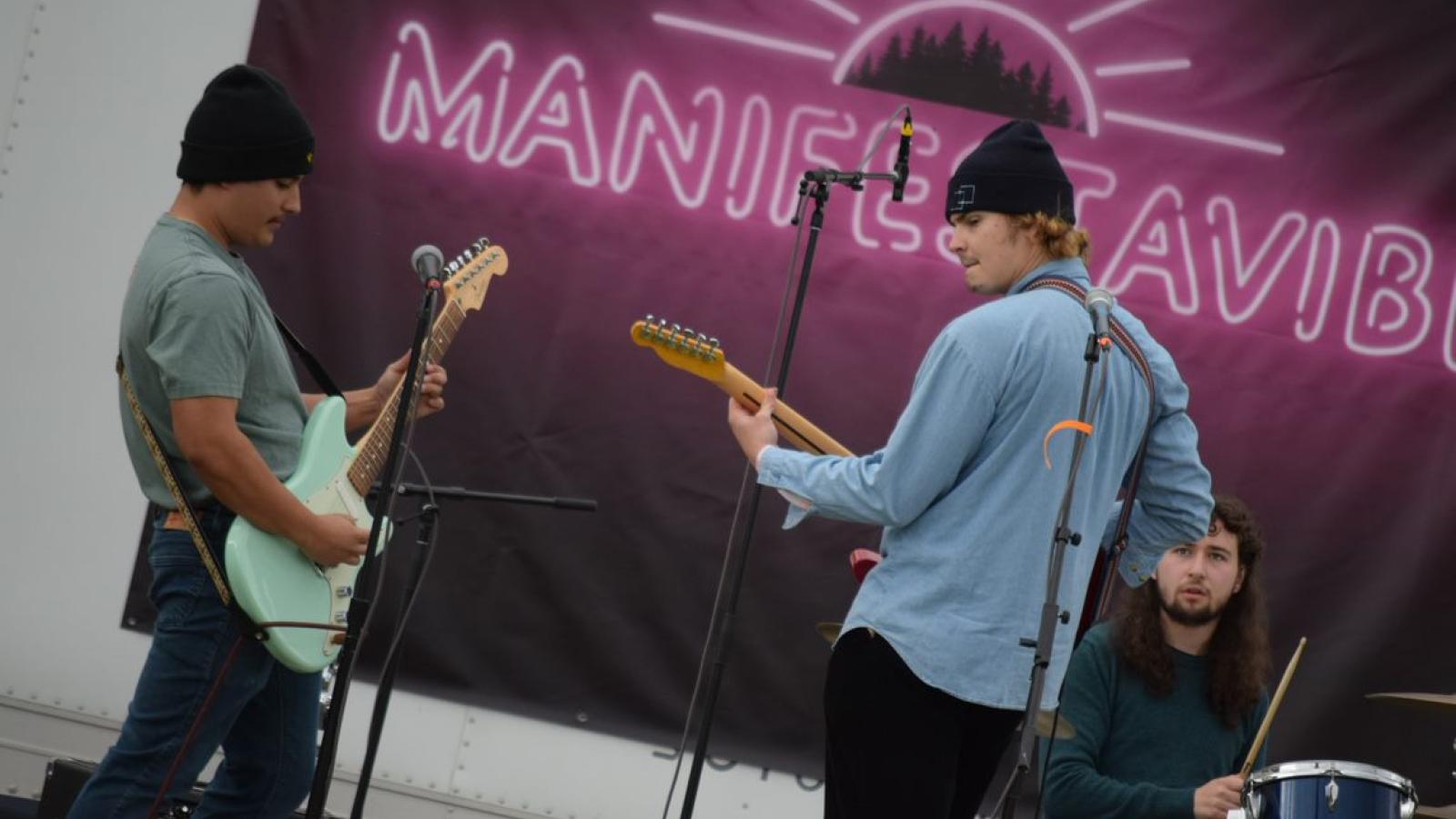 Two people playing guitars