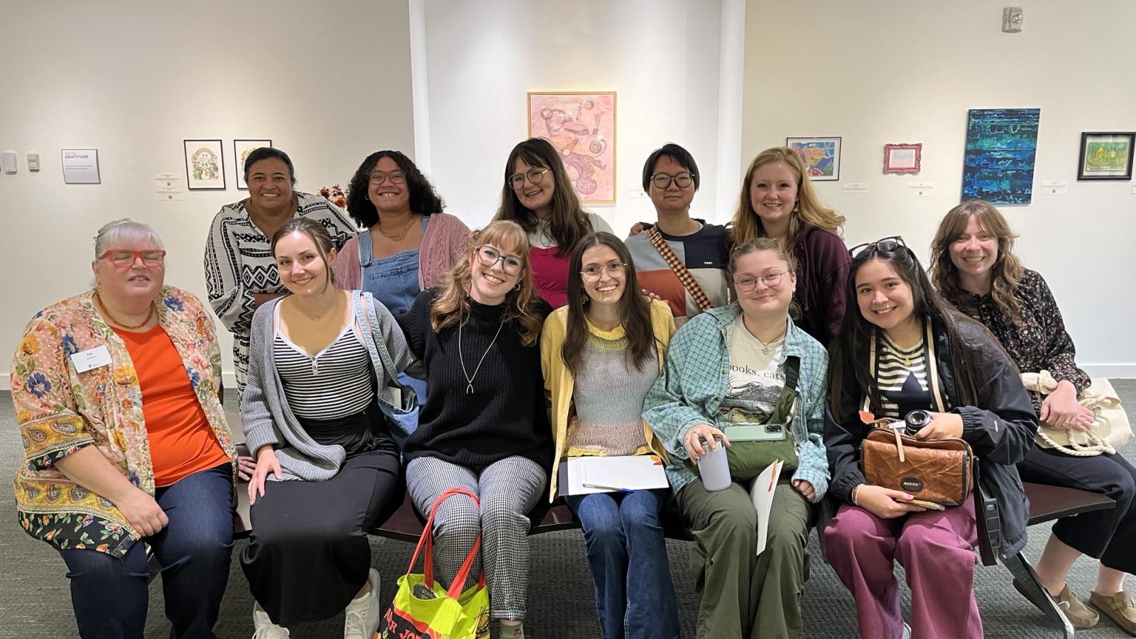 A group of students take a photo in a library
