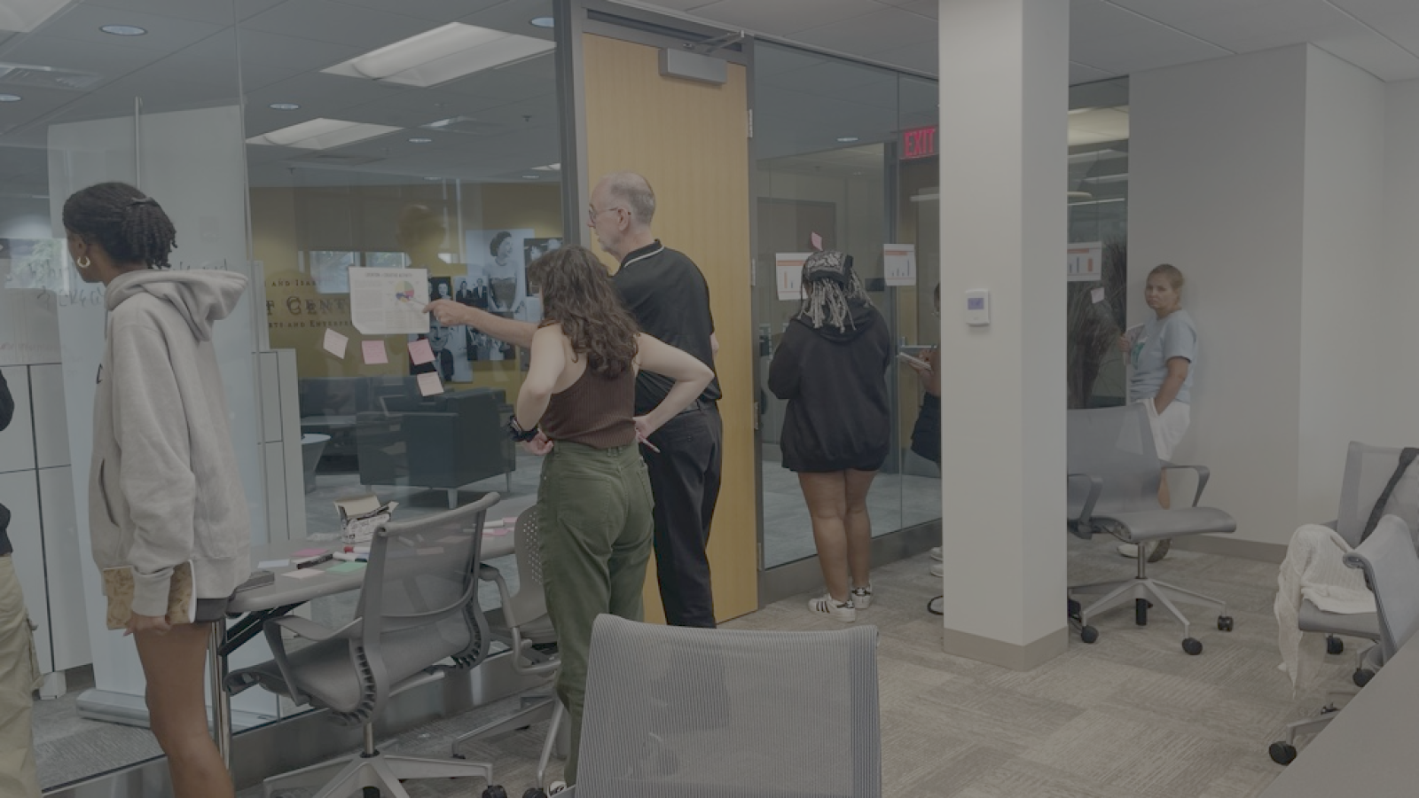 Students looking at notes on a wall