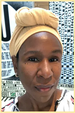 Woman with yellow scarf looking at camera